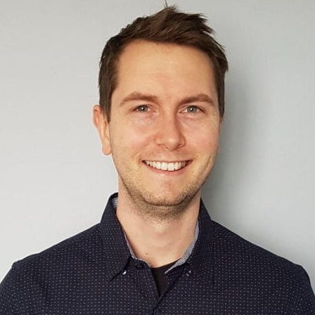 person in buttoned shirt poses for headshot
