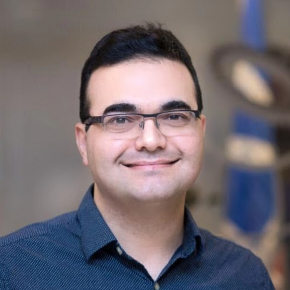 person in collared shirt poses for headshot