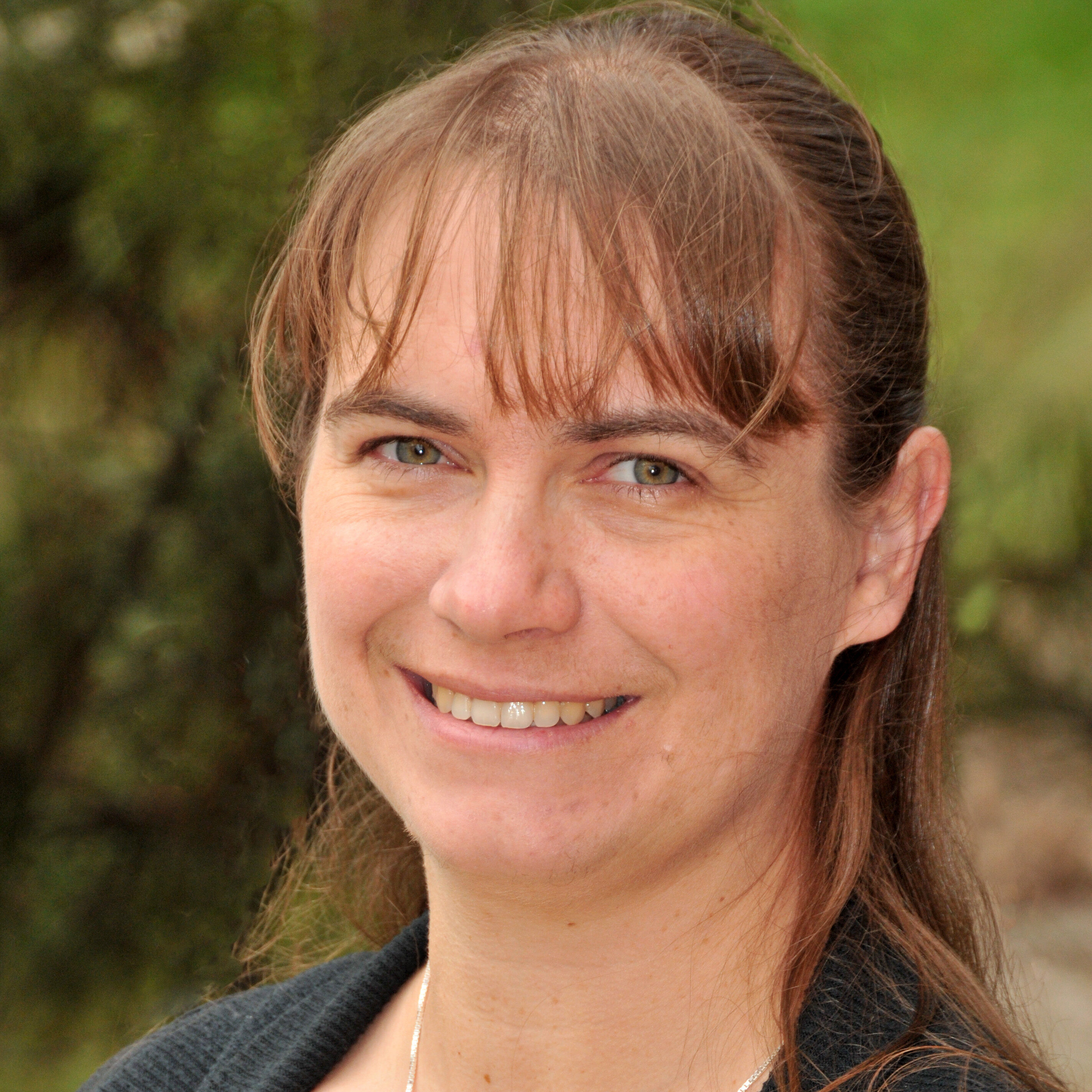 person in black and grey poses for headshot