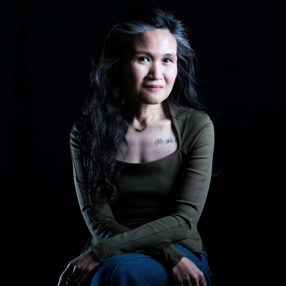 person with long hair poses for headshot