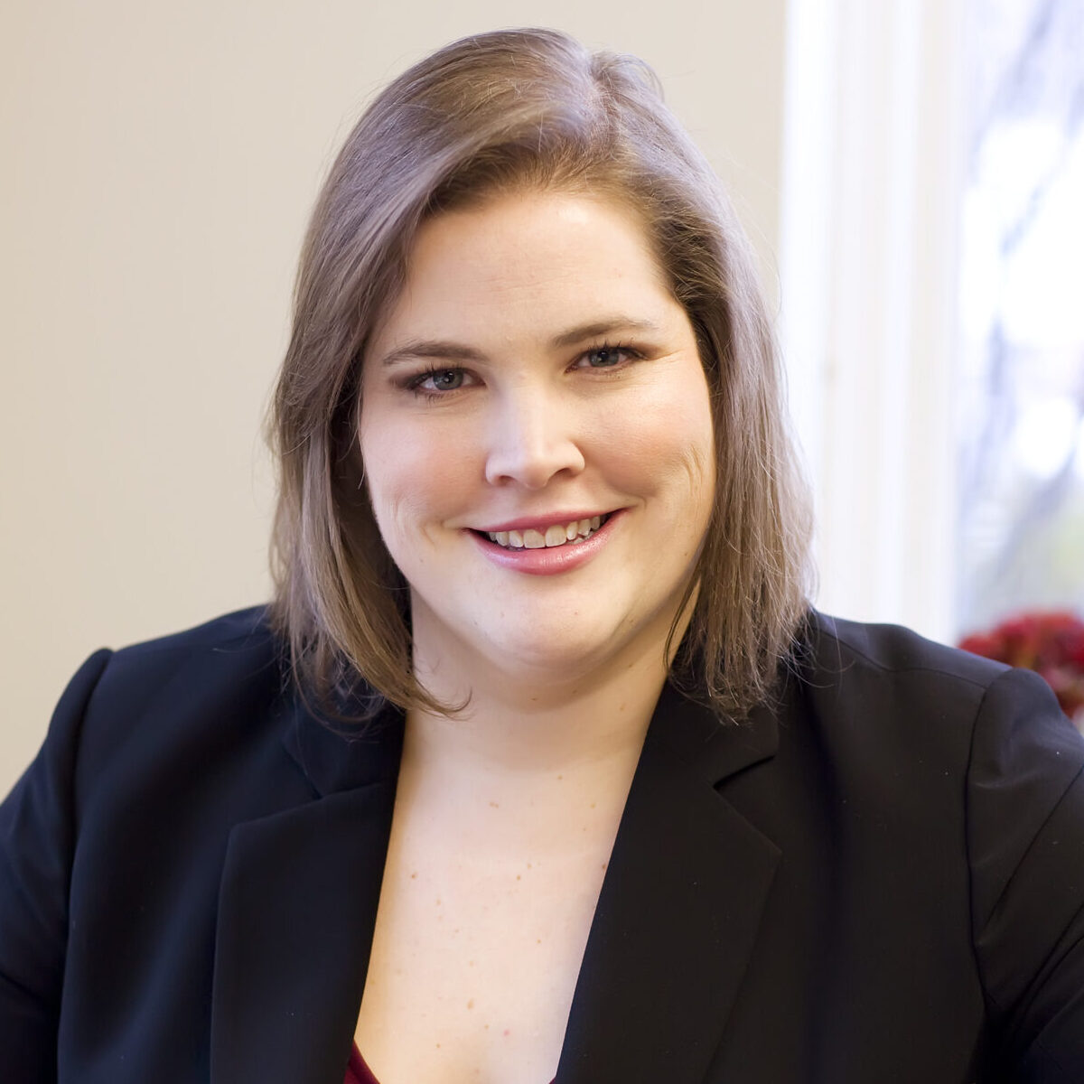 person sitting at table poses for headshot