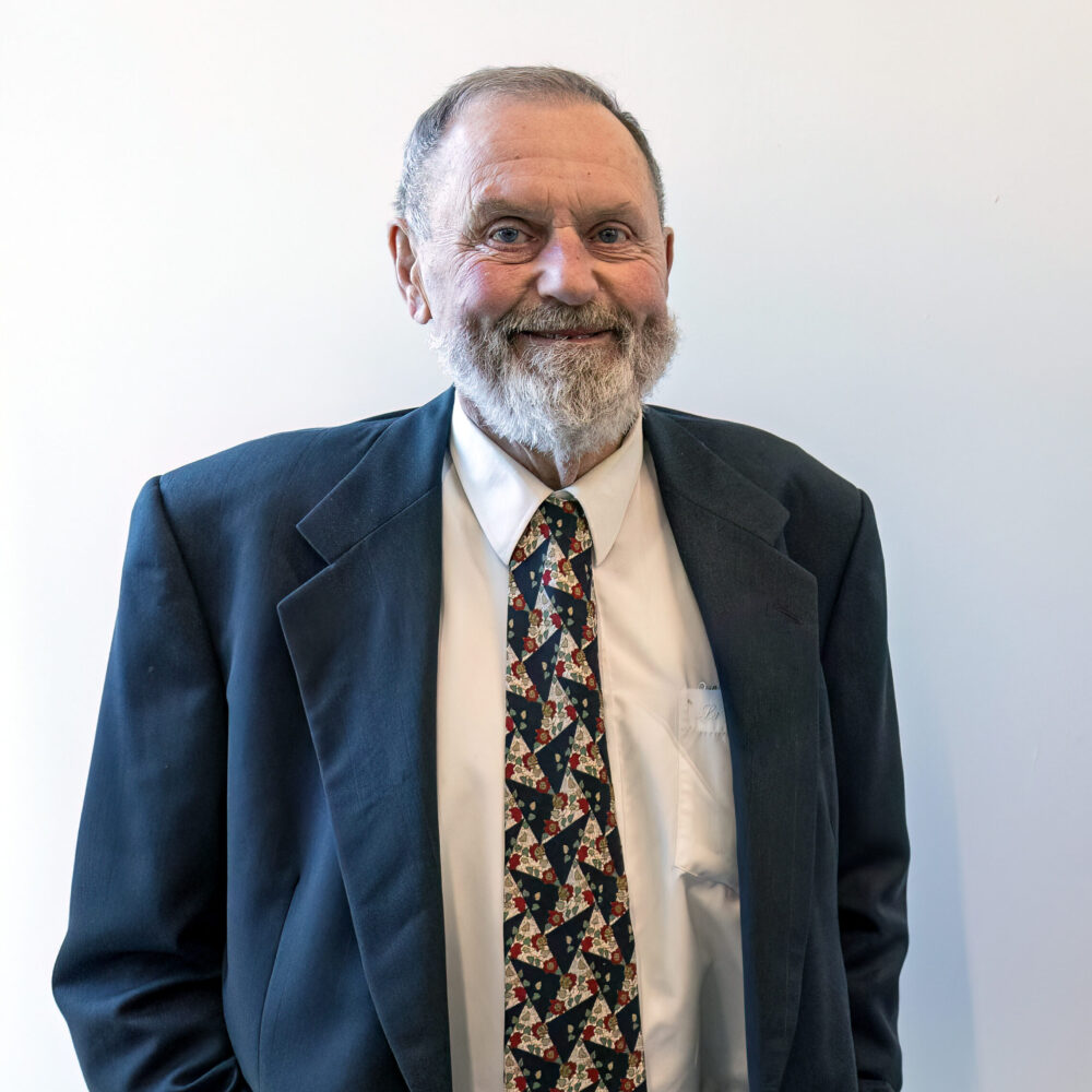 person with beard in suit poses for headshot