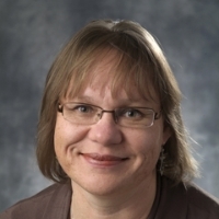 person in glasses poses for headshot